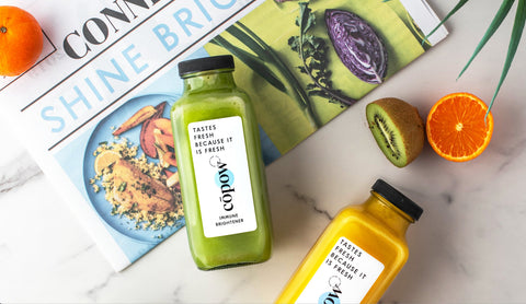 colorful juice by newspaper